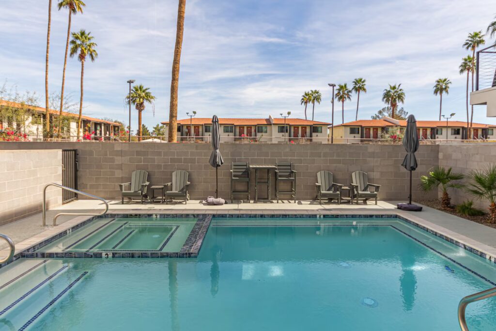Shared outdoor pool with lounge chairs at Modern Luxury at SkySong townhouse rental in Scottsdale